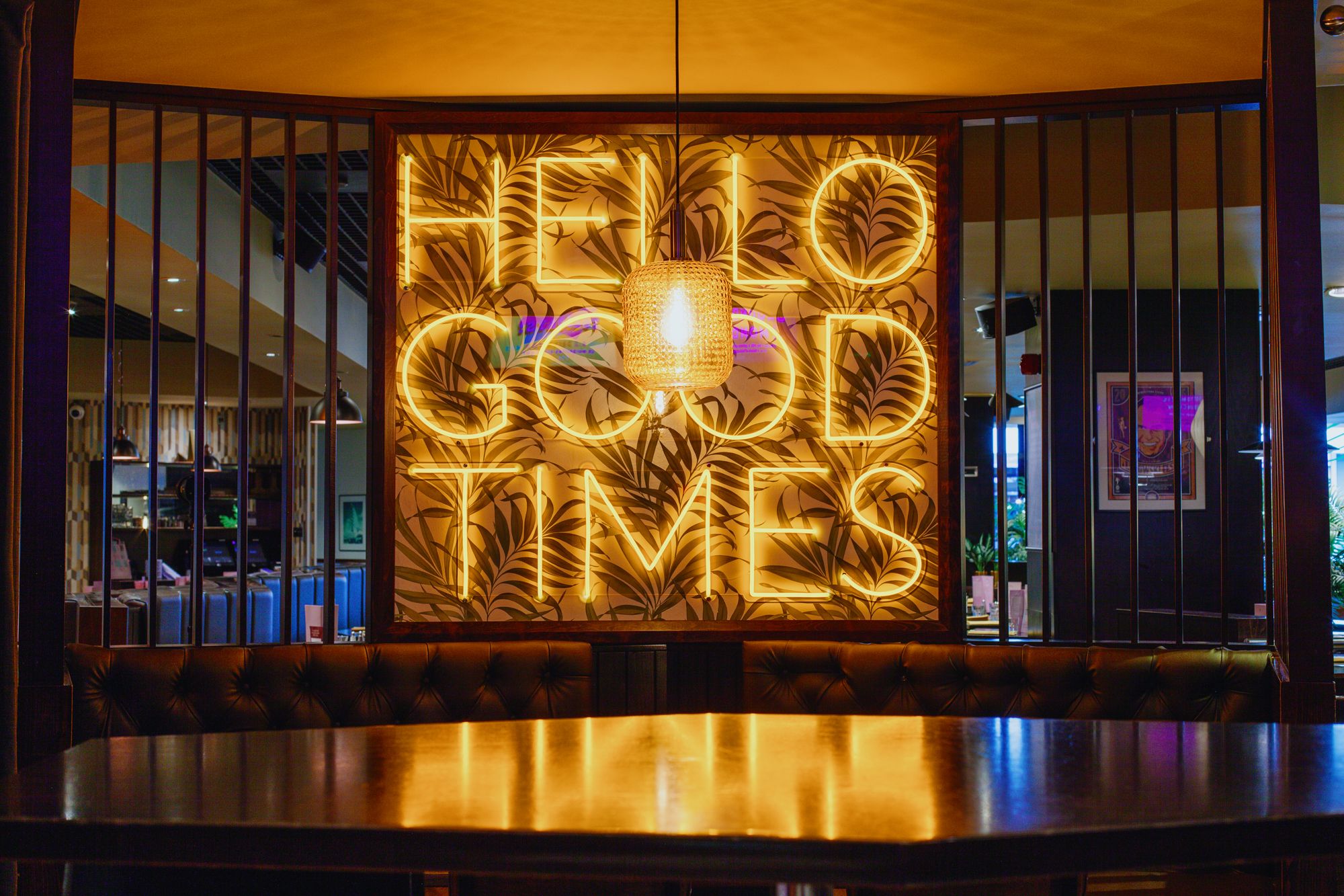 A vibrant neon sign displaying the words "Hello Good Times" in bright colours, radiating a cheerful atmosphere.